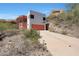 Hillside home featuring long driveway leading to a garage and hillside views at 9932 N 16Th E Pl, Phoenix, AZ 85020