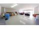 Expansive garage with ample parking space for two cars and additional storage. A blue trash can sits in the corner at 9932 N 16Th E Pl, Phoenix, AZ 85020