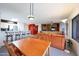 Bright, open-concept living space with wood table, breakfast bar, and built-in media center at 9932 N 16Th E Pl, Phoenix, AZ 85020