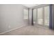 Bedroom with neutral paint, carpeted floors and large windows with pleated shades at 10059 E Tamery Ave, Mesa, AZ 85212