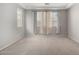 Light-filled bedroom with neutral paint, carpeted floors, tray ceiling and large windows with pleated shades at 10059 E Tamery Ave, Mesa, AZ 85212