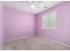 Bedroom with carpeted floors and light purple walls, features a ceiling fan and window with blinds at 10059 E Tamery Ave, Mesa, AZ 85212
