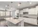 Well-equipped kitchen featuring a center island, stainless steel appliances, and ample counter space at 10059 E Tamery Ave, Mesa, AZ 85212
