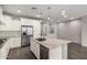Modern kitchen with stainless steel appliances, granite countertops, white cabinets, and a central island with sink at 10059 E Tamery Ave, Mesa, AZ 85212