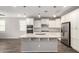 Modern kitchen features a large island with granite countertops, stainless steel appliances, and white cabinetry at 10059 E Tamery Ave, Mesa, AZ 85212