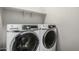 Well-equipped laundry room features front loading washer and dryer plus useful shelving at 10059 E Tamery Ave, Mesa, AZ 85212