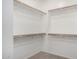 A well-organized walk-in closet with multiple shelves and wooden rods at 10059 E Tamery Ave, Mesa, AZ 85212