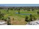 Scenic aerial view of a golf course and a pond surrounded by lush greenery and a picturesque neighborhood at 1035 N Vista Verde --, Litchfield Park, AZ 85340