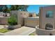 Attractive stucco home featuring a driveway, garage, mature landscaping, and unique architectural elements at 1035 N Vista Verde --, Litchfield Park, AZ 85340