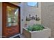 Inviting front entrance featuring a decorative glass door and a small courtyard area at 1035 N Vista Verde --, Litchfield Park, AZ 85340
