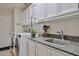 Functional laundry room featuring modern appliances, ample cabinet space, and a utility sink at 1035 N Vista Verde --, Litchfield Park, AZ 85340