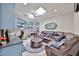 Comfortable seating area with a sofa, a ceiling fan, built in shelving, and plenty of natural light at 1035 N Vista Verde --, Litchfield Park, AZ 85340