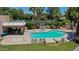 Inviting community pool with lounge chairs, hot tub, shaded seating area, and lush landscaping at 1035 N Vista Verde --, Litchfield Park, AZ 85340