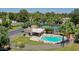 Overhead view of a community pool, tennis court, and recreation area surrounded by lush trees at 1035 N Vista Verde --, Litchfield Park, AZ 85340