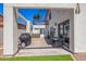 A covered patio features a barbecue grill and plenty of space for outdoor seating and dining at 10386 N 96Th Pl, Scottsdale, AZ 85258