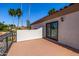 Exterior view of a balcony with a tiled roof and palm tree accents at 10386 N 96Th Pl, Scottsdale, AZ 85258