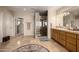 Bright bathroom features a vanity with great storage space and a glass block shower at 10386 N 96Th Pl, Scottsdale, AZ 85258