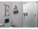 Contemporary bathroom with a glass-enclosed shower and a large decorative letter at 10386 N 96Th Pl, Scottsdale, AZ 85258