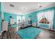 Bright blue bedroom with two carpets, white trim, and a chandelier above the bed at 10386 N 96Th Pl, Scottsdale, AZ 85258