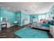 Bright bedroom with turquoise walls, wood floors, and a charming chandelier at 10386 N 96Th Pl, Scottsdale, AZ 85258