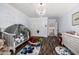 Bright room, with a crib, hardwood floors, and light blue walls at 10386 N 96Th Pl, Scottsdale, AZ 85258