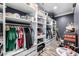 Organized walk-in closet with custom shelving, hanging racks, and ample storage for clothing and accessories at 10386 N 96Th Pl, Scottsdale, AZ 85258