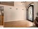 Grand entryway with hardwood floors and an ornate wrought iron doorway at 10386 N 96Th Pl, Scottsdale, AZ 85258