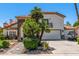 Attractive two-story home with a red tile roof, stone accents, a balcony and desert landscaping at 10386 N 96Th Pl, Scottsdale, AZ 85258