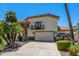 Desirable two-story home featuring a stone accent wall, wrought iron balcony, and an attached two-car garage at 10386 N 96Th Pl, Scottsdale, AZ 85258