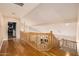 Open hallway with hardwood floors and a wooden banister overlooking the downstairs at 10386 N 96Th Pl, Scottsdale, AZ 85258