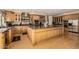 Contemporary kitchen with a large central island, stainless appliances, and wood cabinetry at 10386 N 96Th Pl, Scottsdale, AZ 85258