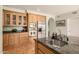 Spacious kitchen featuring stainless steel appliances, granite countertops and custom wood cabinets at 10386 N 96Th Pl, Scottsdale, AZ 85258