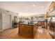 Large kitchen with a center island, modern appliances, wood floors, and natural light at 10386 N 96Th Pl, Scottsdale, AZ 85258