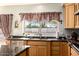 Bright kitchen featuring granite countertops, stainless steel appliances and a window overlooking the backyard at 10386 N 96Th Pl, Scottsdale, AZ 85258