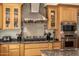 Well-equipped kitchen showcasing a stainless steel range hood, gas cooktop and custom cabinetry at 10386 N 96Th Pl, Scottsdale, AZ 85258