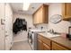 Functional laundry room with cabinetry, sink, and washer-dryer at 10386 N 96Th Pl, Scottsdale, AZ 85258