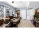 Cozy living room features a comfortable sofa, neutral tile floor, and a convenient cabinet with a sink at 10386 N 96Th Pl, Scottsdale, AZ 85258