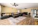 Living room with a large leather sectional, area rug, wood flooring, and neutral walls at 10386 N 96Th Pl, Scottsdale, AZ 85258