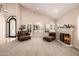 Inviting living room featuring neutral carpet, fireplace, and comfortable armchairs at 10386 N 96Th Pl, Scottsdale, AZ 85258