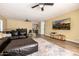 Open living room boasts hard floors, an area rug, a leather sectional, and a wall-mounted television at 10386 N 96Th Pl, Scottsdale, AZ 85258