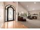 Spacious living room featuring a fireplace, large arched doorway, and comfortable seating at 10386 N 96Th Pl, Scottsdale, AZ 85258