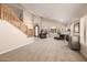 Open concept living room with neutral carpet, fireplace and staircase at 10386 N 96Th Pl, Scottsdale, AZ 85258