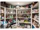 Walk-in pantry with white shelving providing ample storage space for food and household items at 10386 N 96Th Pl, Scottsdale, AZ 85258