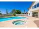 A gorgeous in-ground pool and spa are surrounded by a well-maintained patio with mature desert landscaping at 10386 N 96Th Pl, Scottsdale, AZ 85258
