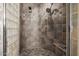 Walk-in shower featuring unique, decorative tile and a convenient shower bench at 10386 N 96Th Pl, Scottsdale, AZ 85258
