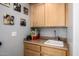 This light wood cabinet includes a sink and storage, creating a functional and stylish area at 10386 N 96Th Pl, Scottsdale, AZ 85258