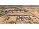 Desert home with solar panels is surrounded by neighboring homes in a developing community at 10539 W Tamara Dr, Casa Grande, AZ 85193
