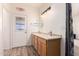 Bright bathroom featuring double sinks, and an exit door for convenience at 10539 W Tamara Dr, Casa Grande, AZ 85193