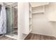 A clean bathroom features a glass shower, vinyl floors, and a white storage cabinet at 10539 W Tamara Dr, Casa Grande, AZ 85193