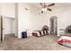 Bright bedroom features neutral carpet, two twin beds, and arched entryway to ensuite bathroom at 10539 W Tamara Dr, Casa Grande, AZ 85193